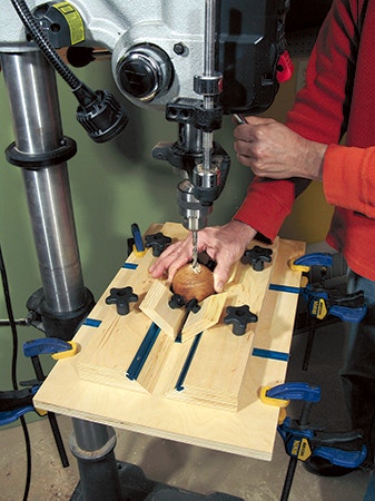 Drilling hole in a ball using a drill press and jig