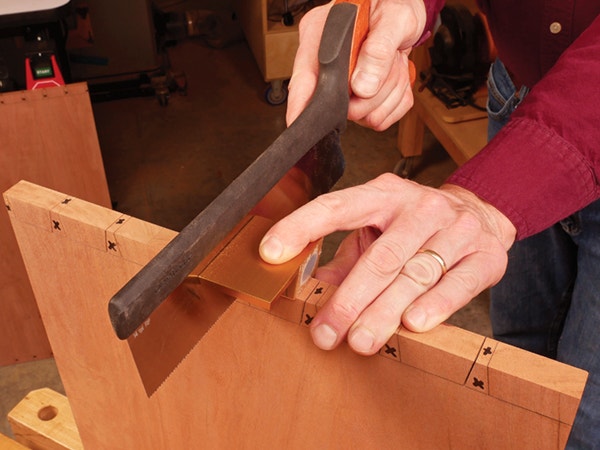 Using a dovetail saw to cut out dovetail sockets